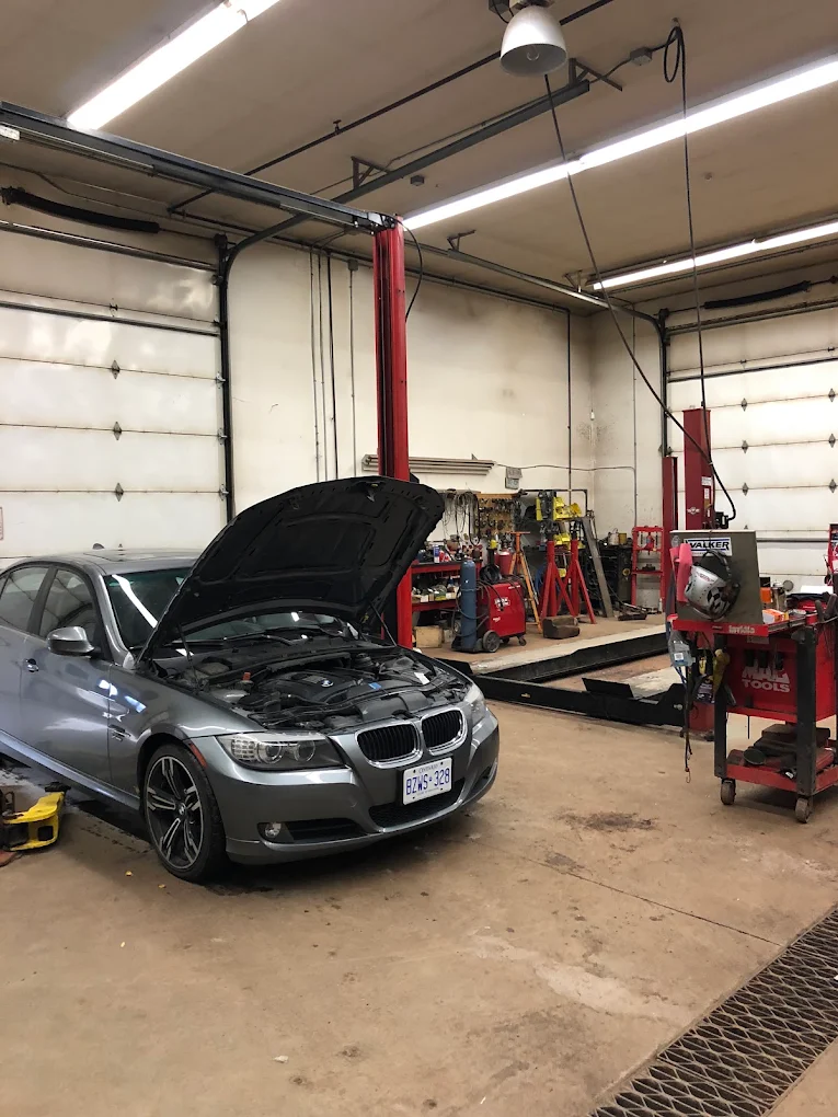 BMW with the hood up in the service bay at Pete's Muffler during routine maintenance