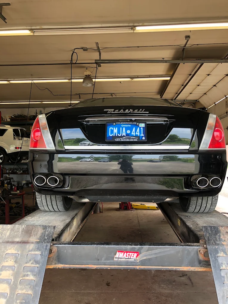 Maserati Quattroporte on the drive-on lift with quad chrome exhaust tips