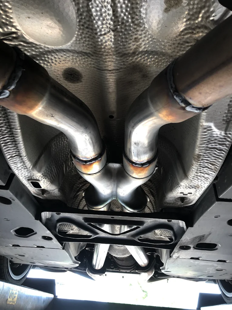 Polished stainless steel X-pipe fabricated and welded in-house at Pete's Muffler in Guelph