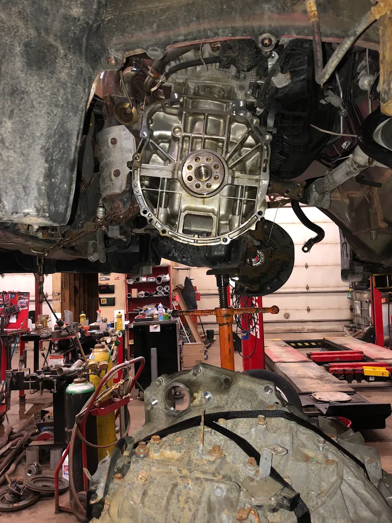 Transmission removed from a vehicle on a transmission jack with the bellhousing exposed