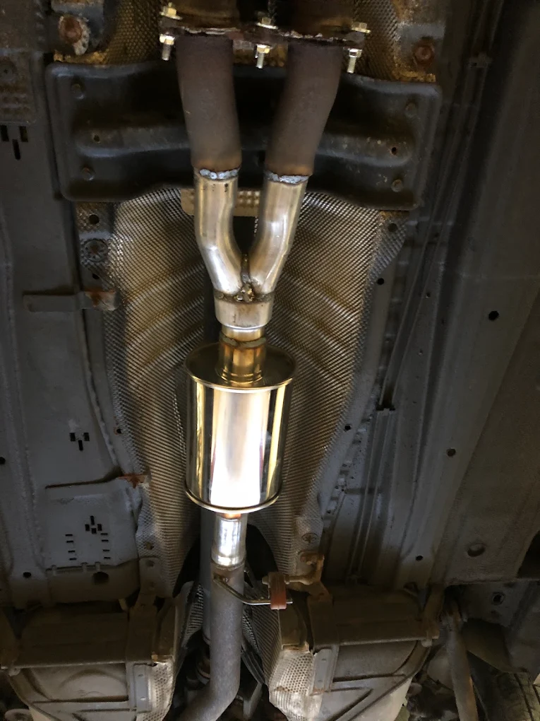 Newly fabricated stainless Y-pipe and resonator welded into place under a vehicle