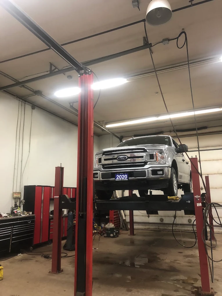 Ford F-150 raised on the two-post hoist for a full inspection at Pete's Muffler & Automotive