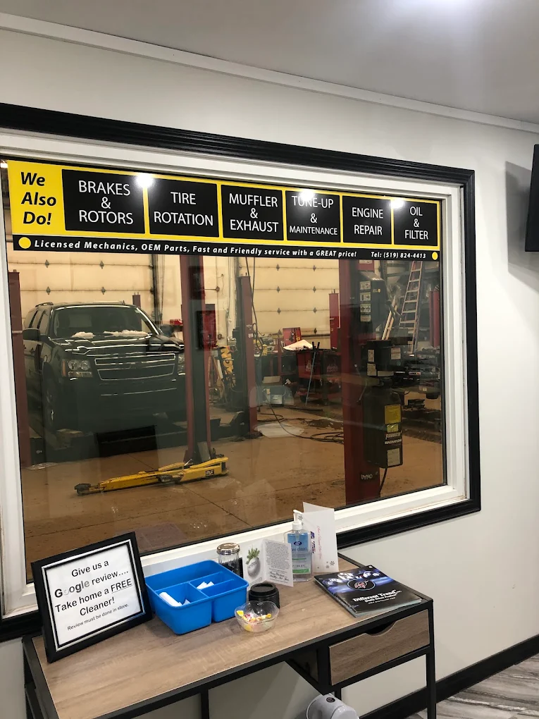 Customer waiting area with the services board and a view into the workshop